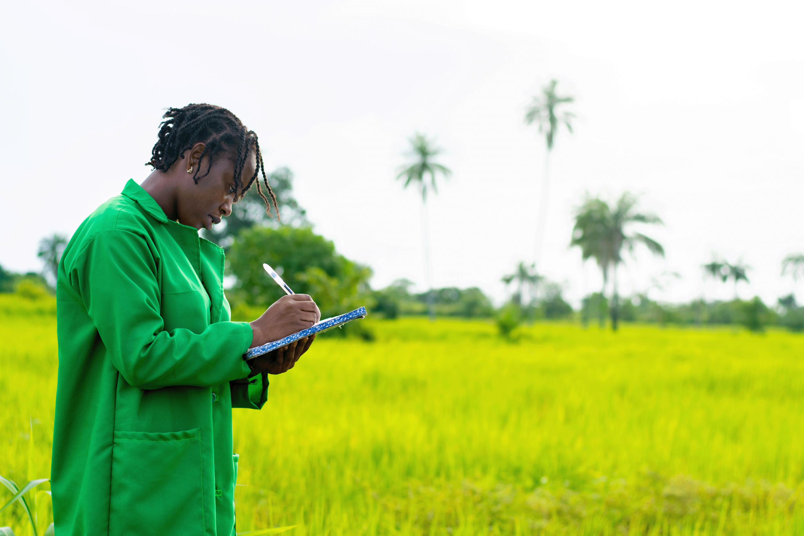 african farmer taking notes farm